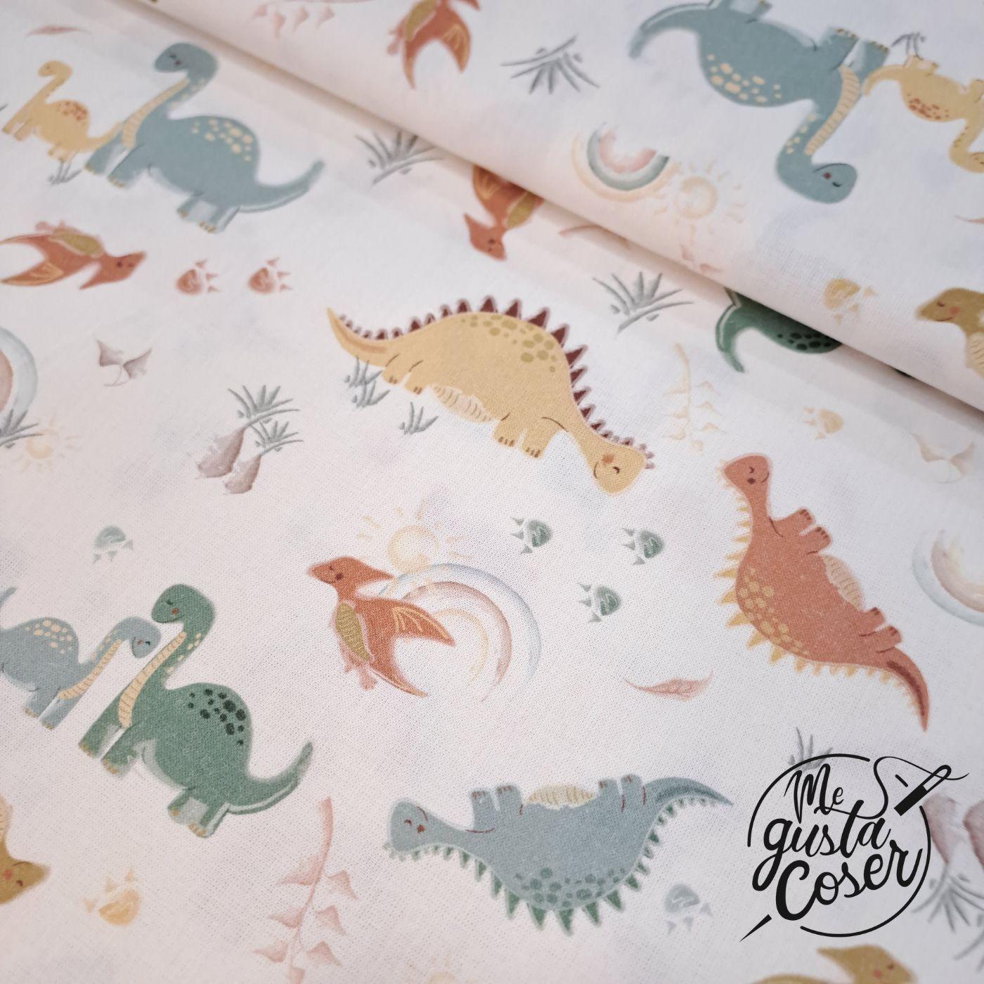 Popelín de algodón con dinosaurios en tonos pastel